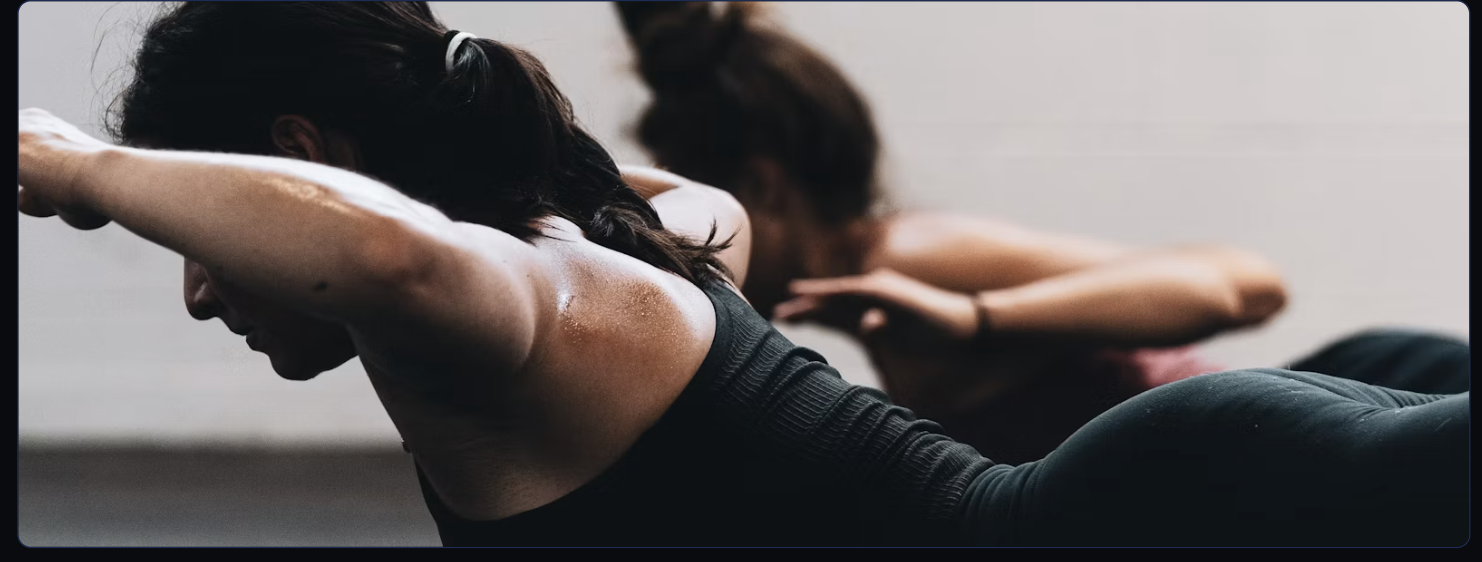 The Elite Pilates studio floor with a row of luxury reformer machines under sculpted lighting